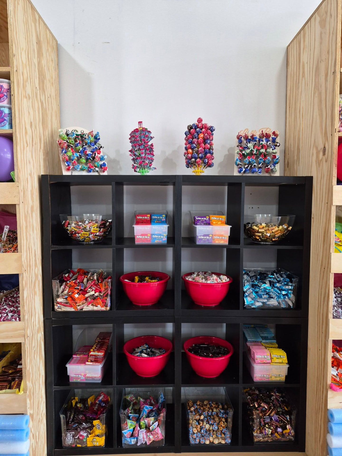 Wall of colorful candy jars and treats at the Busy B's studio